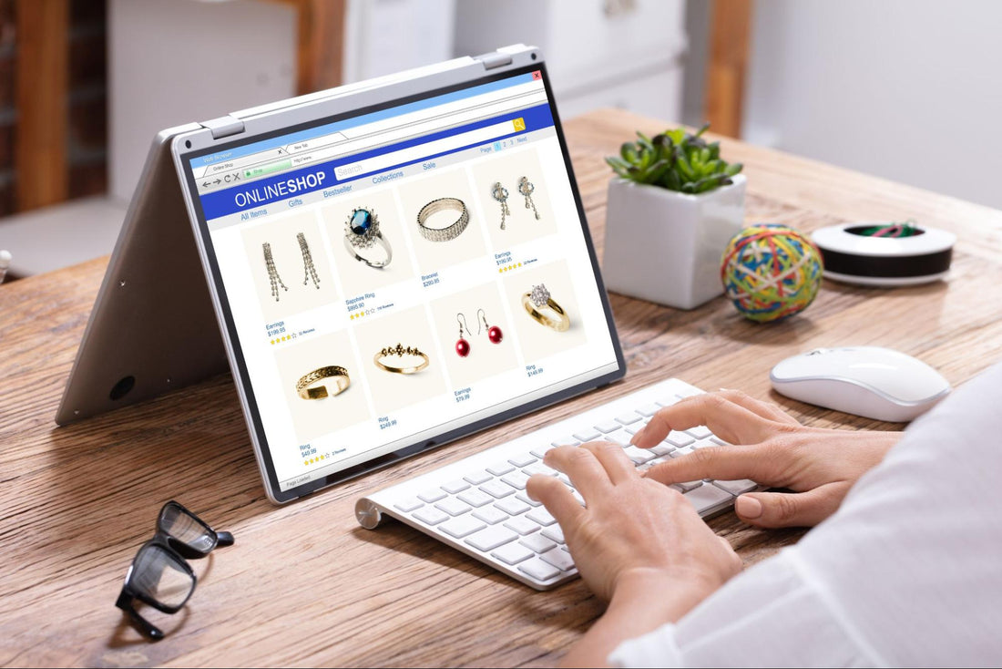 Person browsing an online jewelry store on a laptop, displaying various jewelry pieces for sale.